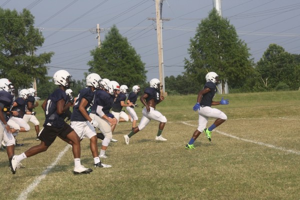 The Marquette Mustangs football squad during sprints on July 22, the second day of July training camp.