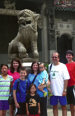 Liggett poses with new members of family in china. He adopted two children this summer.
Published with permission by Bruce Ligget