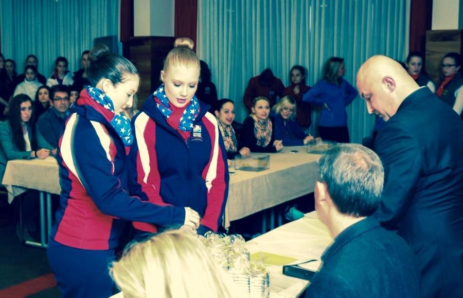 Savannah Lockwood, senior, (right) and teammate draw chocolates to determine the order of competition at the Mozart Cup in Salzburg, Austria. The team will compete Thursday, January 23. Photograph printed with permission by Savannah Lockwood.