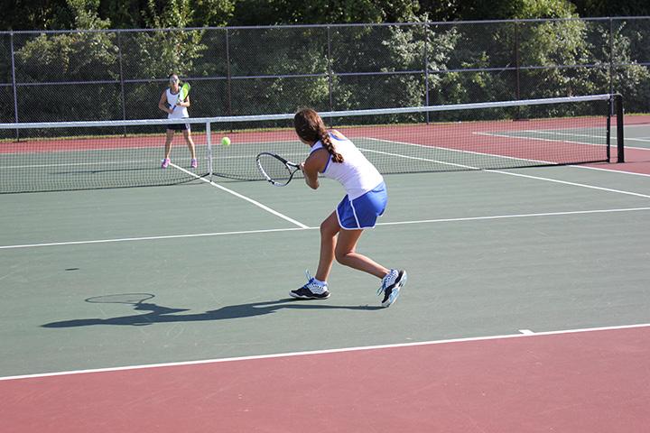 Hetty Bai, senior, competes against a Ladue player in a varsity tennis game. 
