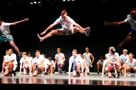 Andy Heller, senior, does a mid-air splits while performing the group dance in the Mr.Mustang pageant. 
