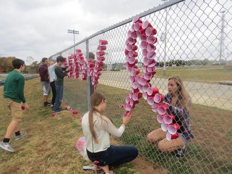 Sophomores Lizzy Konopelski and Paige Knittle decorate for Red Ribbon Week, the week of Oct. 26. SADD members planned the week with the help of National Council on Alcoholism and Drug Abuse representative, Lori Krueger.