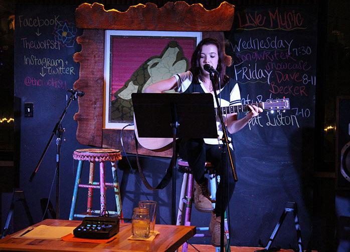 Jillian Hyink, sophomore, performs Maroon 5’s “Sunday Morning” at The Wolf’s open mic night on Tuesday, Nov. 3. Hyink started performing at open mic a year and a half ago. 