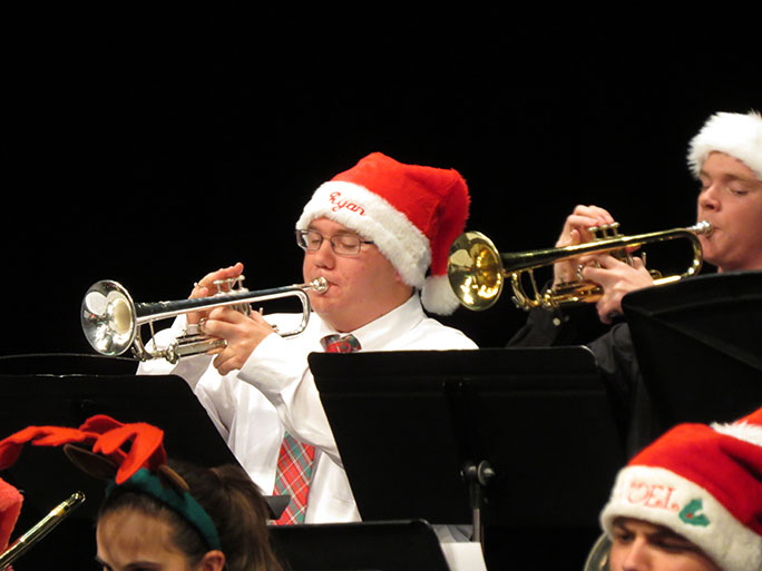 Jazz Ensemble member and junior,Ryan Ingli playing the trumpet in a rendition of Rudolph the red nose reindeer.