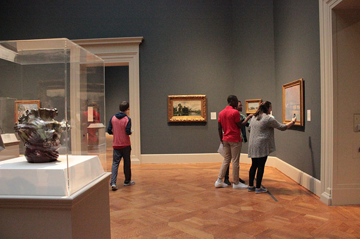 Students take pictures of paintings during a French IV and V field trip to the St. Louis Art Museum on Mar. 1, 2016.