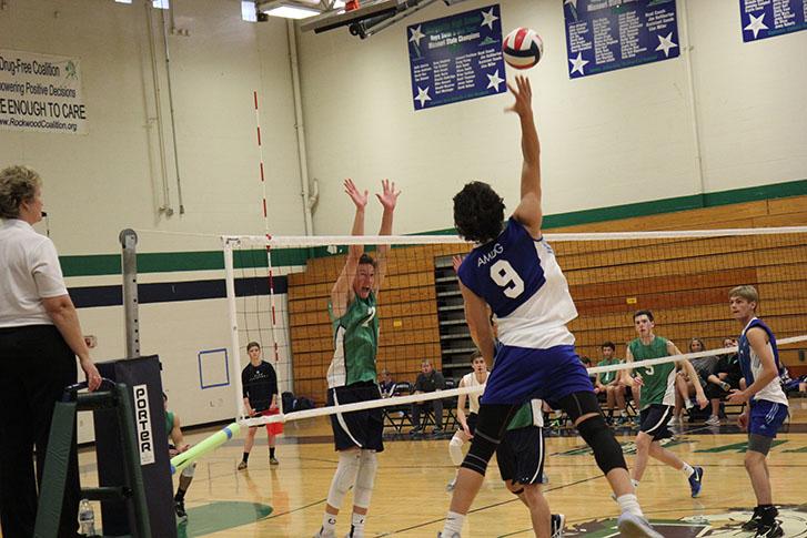Senior, Grant Vollmer, gets his game face on as he attempts to block one of SLUHs power hitters in the from row