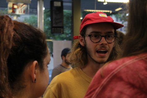 Nick Vaaler, Class of 2015, speaks with several guests attending his art show on Friday, Aug. 12. Vaalers primary mediums include watercolor and ink. 