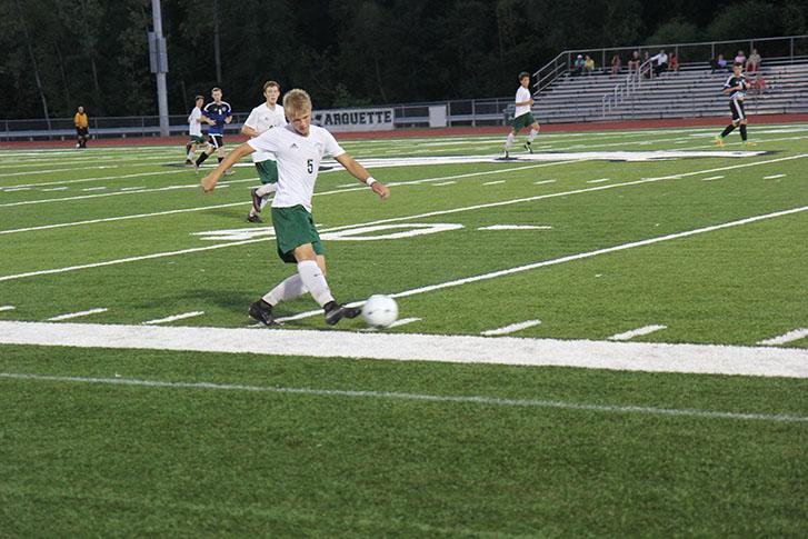 Justin Ernst, senior forward and captain, controls the ball close to the sideline during the game verse Northwest.