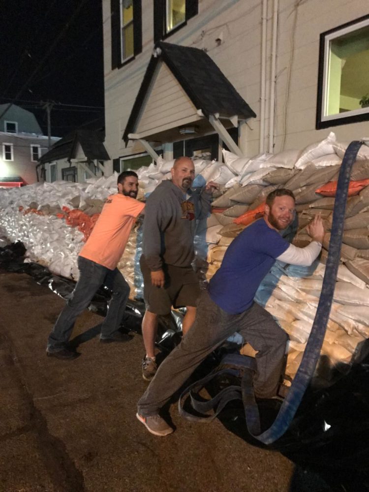 Dr. Greg Mathison, principal, stands in front of the sandbag wall in Eureka. Mathison and other Eureka residents have been working to build the wall since rain started on Saturday, April 29.