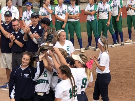 Kelsey Lenox, Lillie Knesel, Sydney Dana, seniors, and other members of the varsity Softball team hold up the State Title trophy. MHS beat Blue Springs South with a score of 2-0 to earn the title.