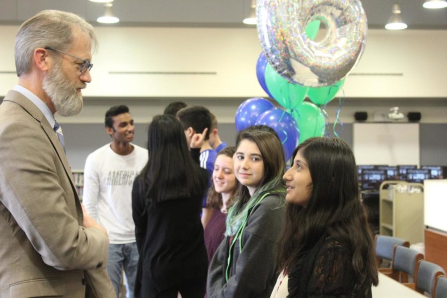 Sriya Kosaraju, sophomore, talks with Superintendent Dr. Eric Knost as he congratulates her on her perfect ACT score. Kosaraju was one of nine students who received a perfect score of 36 on her ACT.