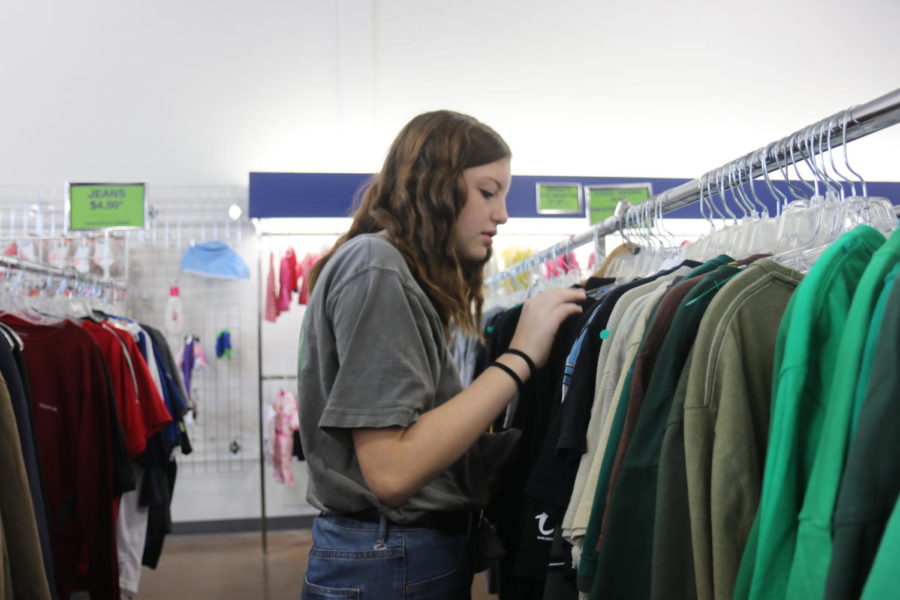 Elise Ambler, sophomore, browses through the men’s section at Goodwill. “Look in places where you wouldn’t expect to find things. Like I always look in the men’s department,” Ambler said. She - like many teens in MHS - loves to thrift shop in her free time. 