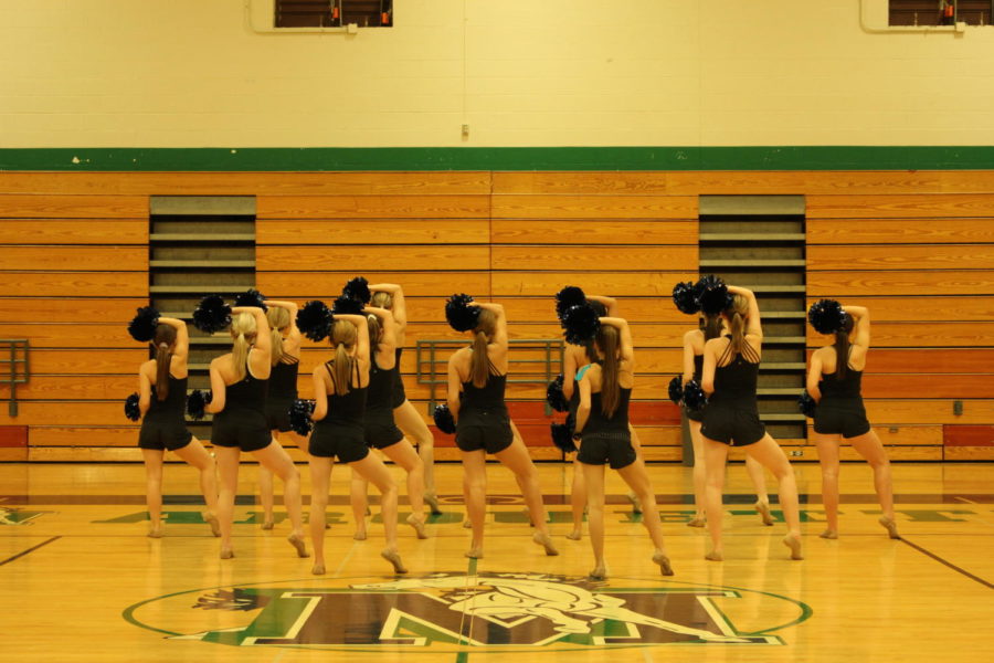 The Varsity Mystique girls hold an early-morning practice before Regionals to make the dance as flawless as possible. These girls have practices three times a week - twice after school and one before school.
