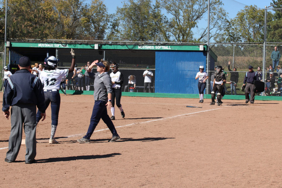 Amy Doyle high fives Tayler Emerson, senior, following a triple in the quarter finals game.