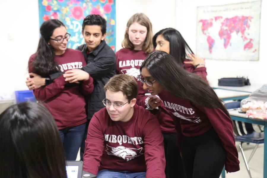 (Front right) Shruti Punnachalil, junior, works during fourth hour to contact all 904 judges to tell them that the 2019 Marquette Speech and Debate tournament is cancelled due to weather. Punnachalil said many of the judges were members of the MHS community, who would also be affected by the weather. “Our parents donate a lot of their time, a lot of my family friends have too,” Punnachalil said. “The communities also tend to know when the Marquette tournament is, and its a really great place for people to see each other because they all tend to reunite at our tournament.” 
