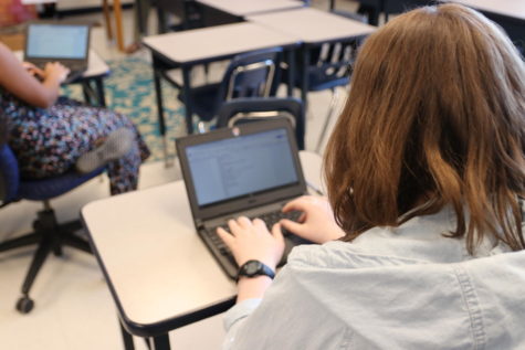 Molly Millsaps, senior, types a poem on her chromebook for the contest. She is a member of the poetry club and said poetry is sometimes shown in a negative light in schools. “I hear a lot of teachers say that poetry is complicated and confusing,” Millsaps said. “Because of this, students are drawn away from it sometimes.”