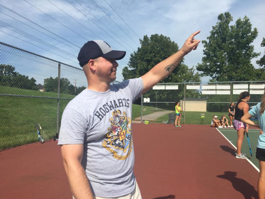 Joshua Hyde, history teacher, leads the j.v. girls tennis team in a series of drills prior to practice. He has become a co-coach of the girls’ tennis team this year with Alex Nelle, history teacher.