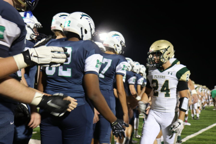 Players from Lindbergh High School’s team, the Flyers, shake hands with the Mustangs as a show of good sportsmanship following the game. The Mustangs won 37 to 14. 