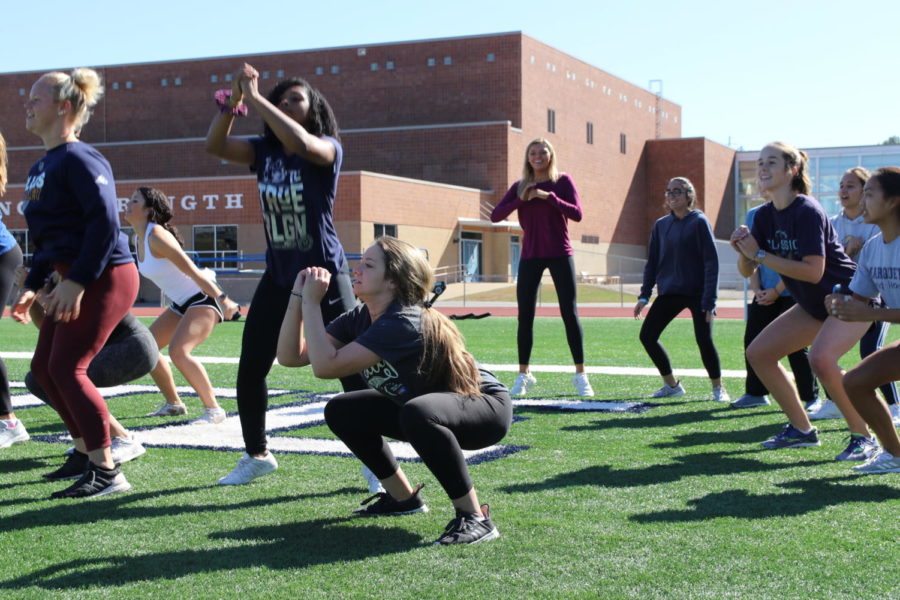(Center) Melody Hollenbeck, senior, lands after doing a jump squat during Advanced Strength Training. Hollenbeck took the course after being encouraged by her cheer coaches. A lot of [the cheerleaders] like the class because its a nice break in the day,