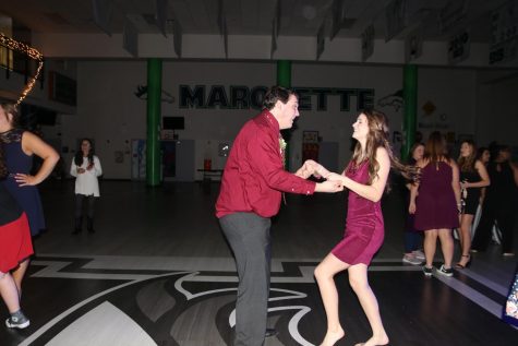 Juniors Natalie Anderson and AJ Burger dance together. Anderson has attended the dance every year since her freshman year and prefers it to Homecoming because she said there are always fewer people and better music. “I just go because she goes,” Burger said. 