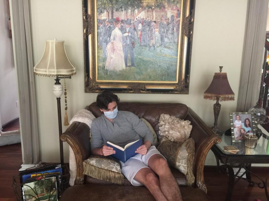 Christian Springer, sophomore, reads a book while social distancing in his house.
