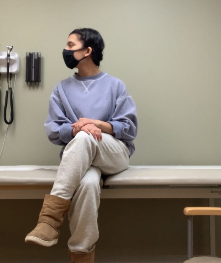 Zara Tola, copy editor, patiently waits for her COVID-19 tests results in the examination room at Total Access Urgent Care. Although she tested negative for COVID-19, Tola must quarantine through Wednesday, March 10.