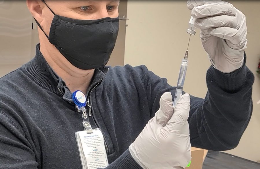 Steve Frigo, executive director of pharmacy at Mercy Hospital prepares a COVID-19 vaccine. The vaccine arrives at a facility in a box of dry ice and is immediately transferred to an ultracold freezer, where it is stored at -80 degrees Celsius. It is then thawed in a refrigerator for up to five days. Before usage, the vaccine is diluted with saline solution and is good for up to six hours.