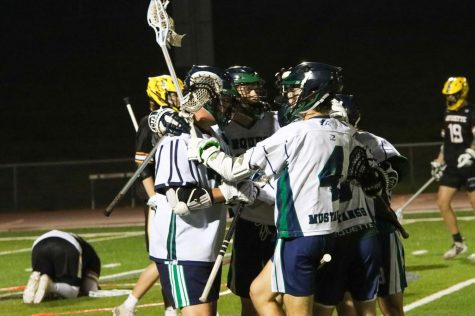 The Mustangs celebrate after midfielder Patrick Kirwan, senior, scores the game winning goal with 6 seconds left in the game. The Mustangs will face off against the Lindbergh Flyers at 7 p.m. on Friday May 21.
