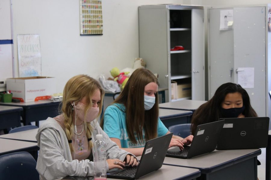 Sophomores Aubrey Bast, Marrisa Hale and Emma Hasler work in their English 10 class while wearing masks, which is an RSD enforced rule. Recently, the Center of Disease Control (CDC) announced those fully vaccinated could go without masks except where laws and regulations still require masks.