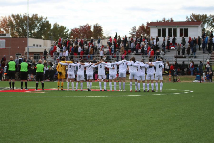 The starting lineup embraces each other while the National Anthem plays before the game on Saturday, Nov. 13. The team lost 1-0 against Jackson High School in overtime. 
