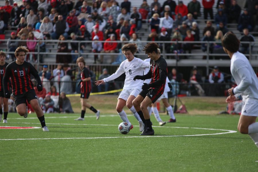 Junior Carter Bier, center midfielder, successfully wins a challenge in the middle of the field leading the boys to counter on the other teams defense for a chance at a goal in the State Quarterfinal game against Jackson High School (JHS) Saturday, Nov. 13. JHS won 1-0 in overtime.