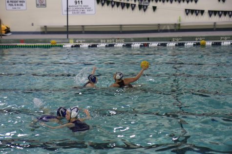 Bri Allstun, senior, passes the ball to her teammate during a 3-on-3 drill. Districts for girls water polo started on May 9, and the state championship will be held on May 14. “We started out a little bumpy, but now I think we’re getting there, and we’re going to be ready for State,” Allstun said.