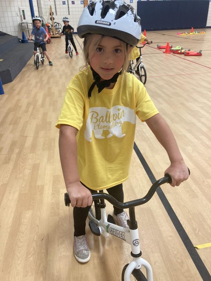 Giavanna+Garza%2C+kindergartner%2C+practices+riding+a+bike+at+Ballwin+Elementary+after+the+school+received+bikes+from+Living+On+Two+Wheels.+%E2%80%9COnly+if+I+can+go+fast%2C+I+can+ride+a+bike+without+training+wheels%2C%E2%80%9D+Garza+said.