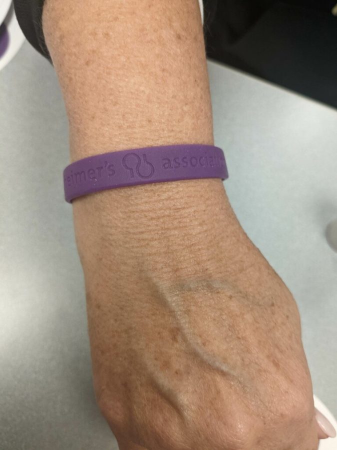 Lisa Nieder is sporting the purple bracelets given to teachers once they make their donation.  The bracelet says alzheimer’s association, which is the organization RSD staff donate to. The donations go towards funding research and supporting those with alzheimer’s.