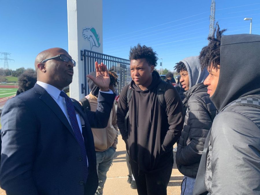 Superintendent Dr. Curtis Cain advises students Malik Johnson, Douglas Clark, and Jox Levison on evacuation procedures after the school day was promptly ended as a result of a social media threat.