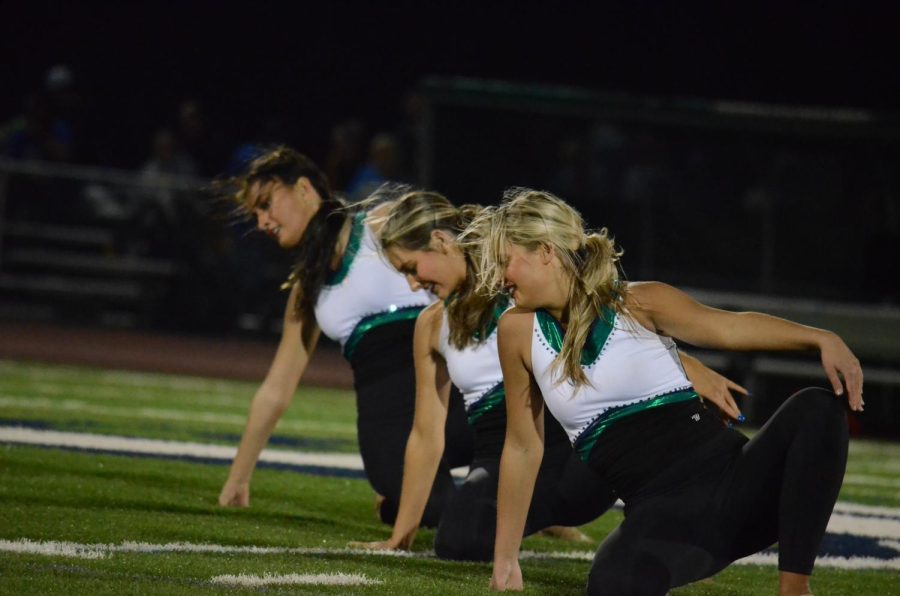 Varsity Mystique performs their halftime routine at the MHS vs. Seckman districts game to support their team. We love cheering and dancing for our Mustangs, Allison Markus, head coach, said. Ask any of the girls, their favorite thing is football games.