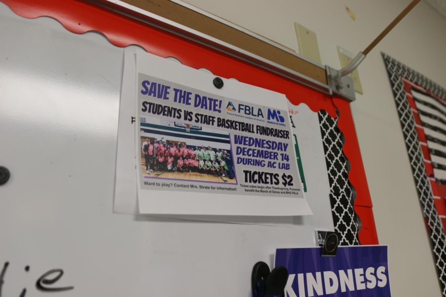 Pamphlet advertising the FBLA basketball game in a classroom.