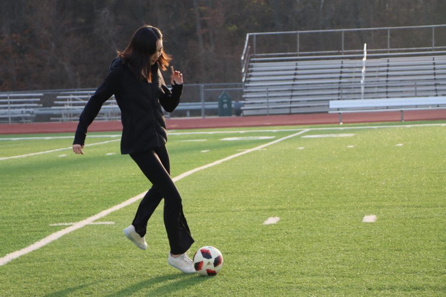 Chloe Kang, senior, dribbles the ball down the field. While Kang does not play competitive soccer, she enjoys watching the South Korean national team play in the FIFA World Cup. “It’s just great seeing Korea represented as a whole on the world stage,” Kang said. 