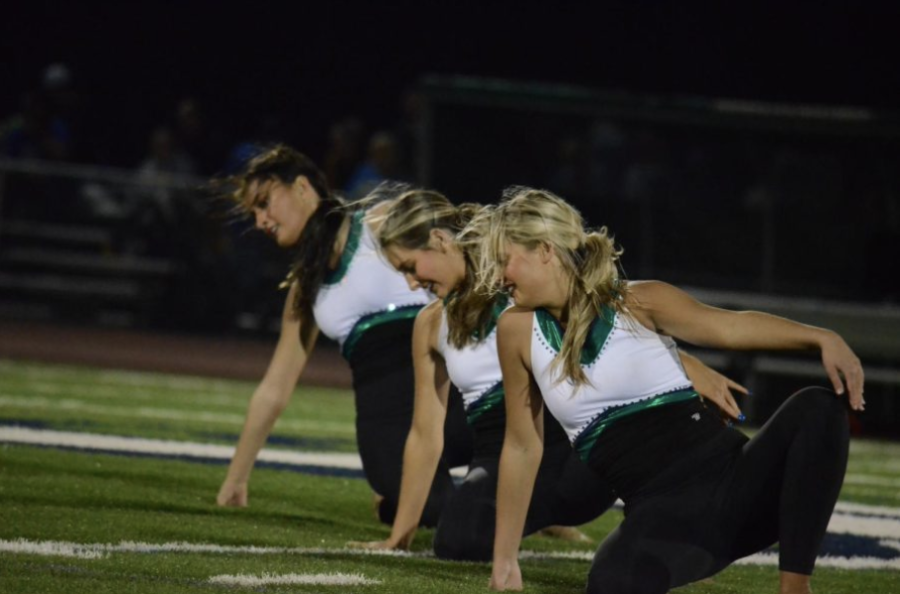 Varsity Mystique performs their halftime routine at the MHS vs. Seckman districts game to support their team. “We love cheering and dancing for our Mustangs,” Allison Markus, head coach, said. “Ask any of the girls, their favorite thing is football games.”