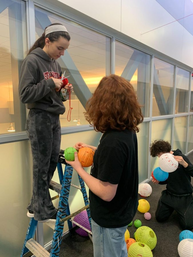 Yana Dragnev, senior, and Carlos Vences, junior, hang up lanterns in the third floor hallway to commemorate Chinese New Year. As student co-founder of the DEI Committee, Dragnevs goal is to implement diversity and acceptance around the school. I do think that its necessary to make sure that everyone feels like heard, she said.