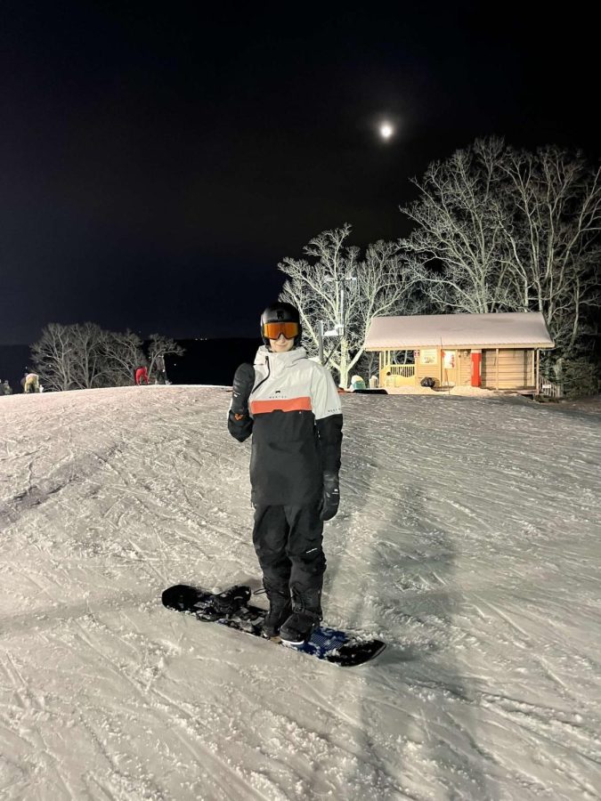 Jordan Stinehagen, senior, finished snowboarding down a slope at hidden valley in Feb 4. Stinehagen started snowboarding this year after skiing since he was a young kid.