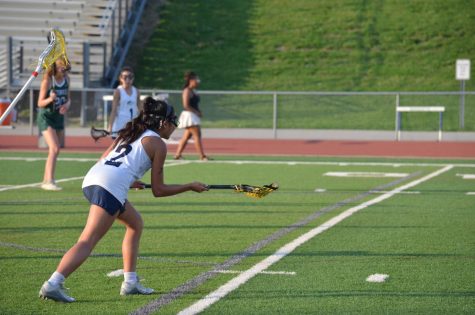 Joyce Liu, senior, prepares to take a goal shot at a game last season against Pattonville on Friday, May 13. Liu said she is enjoying the open fields and is excited for her upcoming senior season. Lacrosse tryouts will begin on Monday, Feb. 27. 