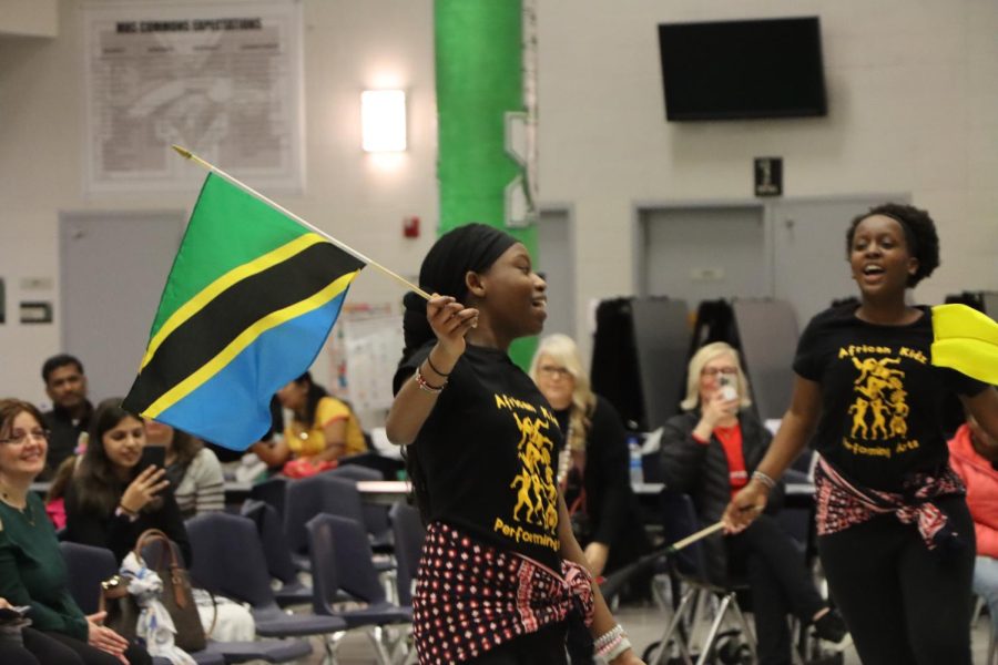 Ramla+Jumat%2C+seventh+grader%2C+waves+the+flag+of+Tanzania+as+a+part+of+a+performance+with+the+African+Kidz+Performing+Arts+group+at+the+first+ever+Festival+of+Nations+at+MHS+Wednesday%2C+March+8.+This+event+consisted+of+many+organizations%2C+groups+and+people+performing+dances%2C+setting+up+informational+booths+and+showcasing+different+foods.+Jumat+enjoyed+performing+because+she+wants+people+to+know+more+about+African+culture.+%E2%80%9CI+like+doing+this+because+I+want+our+voices+to+be+heard+by+others%2C%E2%80%9D+Jumat+said.