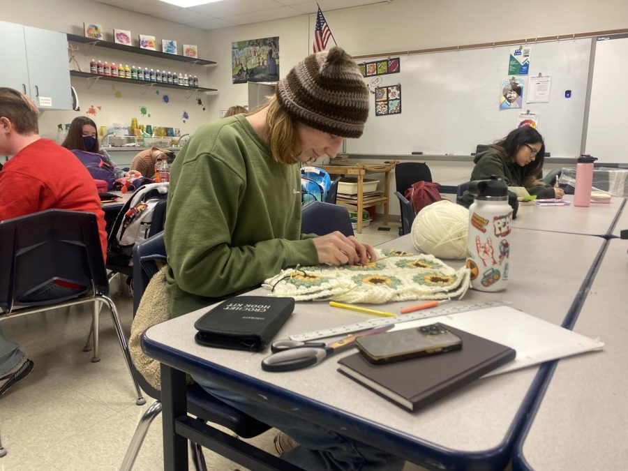 Senior Bryan Craft works on his crochet bag in AP Art Studio. Craft participated in the Eco Art Show and earned second place at MHS and third overall. He hopes to pursue art in the future as well by possibly selling his crochet pieces. 