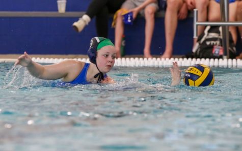 Erin Huff, senior, struggled over the ball with a Ladue defender. She will participate in her fourth year of water polo this year, after a staffing mishap caused difficulties during tryouts. “I’m still looking forward to the season,” Huff said. “Just because it didnt start off well doesn’t mean it cant still end great.”