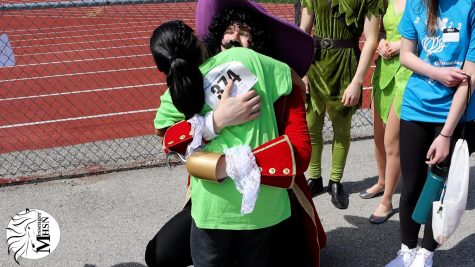 Bryson Weaver, junior, hugs a Special Olympics participant dressed as Captain Hook from Peter Pan. 