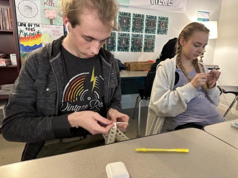 Bryan Craft, senior, crochets flowers at a Stitch Club meeting. The club meets every Wednesday during Mod 1 of Ac Lab, and they focus on learning new hand stitching skills like knitting and crocheting. 