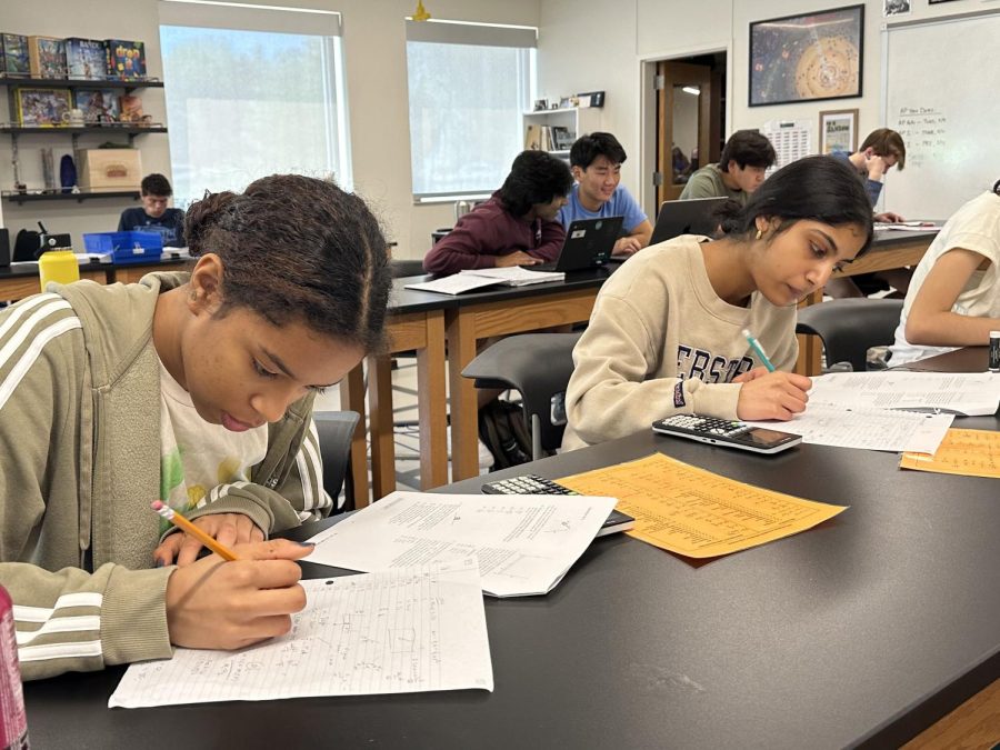 Juniors Anna Hill-Jones and Sanika Saraf study for their AP Advanced Physics AP test during Ac Lab in AJ Sansoms classroom. The exam is Thursday, May 11.
