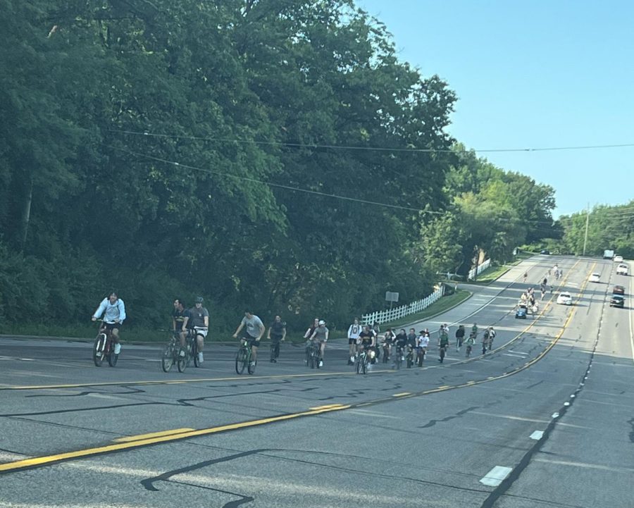 Seniors ride down Clarkson Road on the annual Tour de Clarkson, celebrating senior year. With a police escort, about 50 students rode bikes, golf carts and mowers to school.