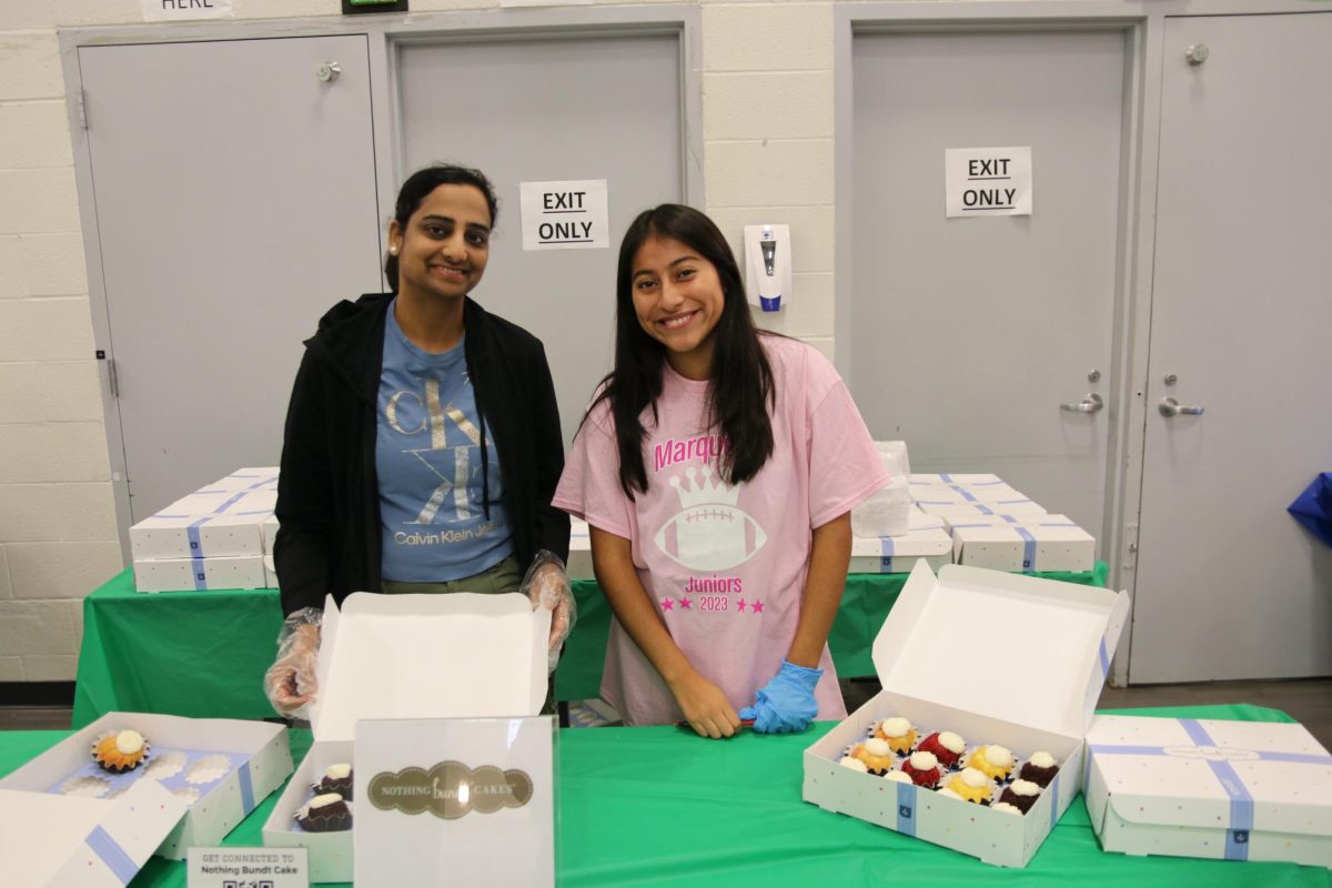 Volunteers Soujanya Kommepalli and Maggie McGinn serve bundt cakes at the Nothing Bundt Cakes booth. Nothing Bundt Cakes is located in Chesterfield, and sells a wide assortment of bundt cake flavors and sizes, for any occasion. 